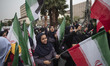Veiled Iranian schoolgirls carrying Iranian flags while taking part in an anti-U.S. and an...