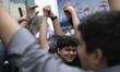 A group of Iranian schoolboys holds-up their hands as the sign of the Unity against Israel...