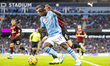 Jeremy Doku #11 of Manchester City challenged by Chris Mepham #6 of AFC Bournemouth during...