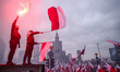 Participants hold flags and flares during 'The Independence March' organized by far right...