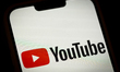 The YouTube logo is seen on a mobile device screen in this illustration photo in Warsaw, P...
