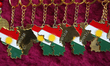 Keychains in the shape of Kurdistan displayed as members of the Kurdish community celebrat...