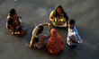 Devotees are seen offering their prayer to setting sun , during Chhath puja festival in Ko...