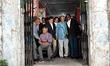 Nobel laureate Prof Muhammad Yunus (C) emerges from the labor court with his lawyers after...