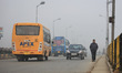 People are walking while vehicles are moving amid dense fog in Baramulla, Jammu and Kashmi...
