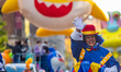 A clown is waving to the crowds at the 97th Macy's Thanksgiving Day Parade in New York, NY...