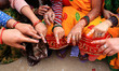 Women in Jaipur, Rajasthan, India, are displaying their fingers marked with indelible ink...