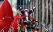 Santa Claus is waving to the crowds from atop the Macy's Santa's Sleigh float during the 9...