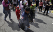 A man is carrying the image of Santa Muerte in Tepito, Mexico City, as he visits her templ...