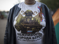 A pro-Russian activist wears a t-shirt reading "Kindness conquers cities. 2014 - year of Russian culture" outside of the occupied regional a...