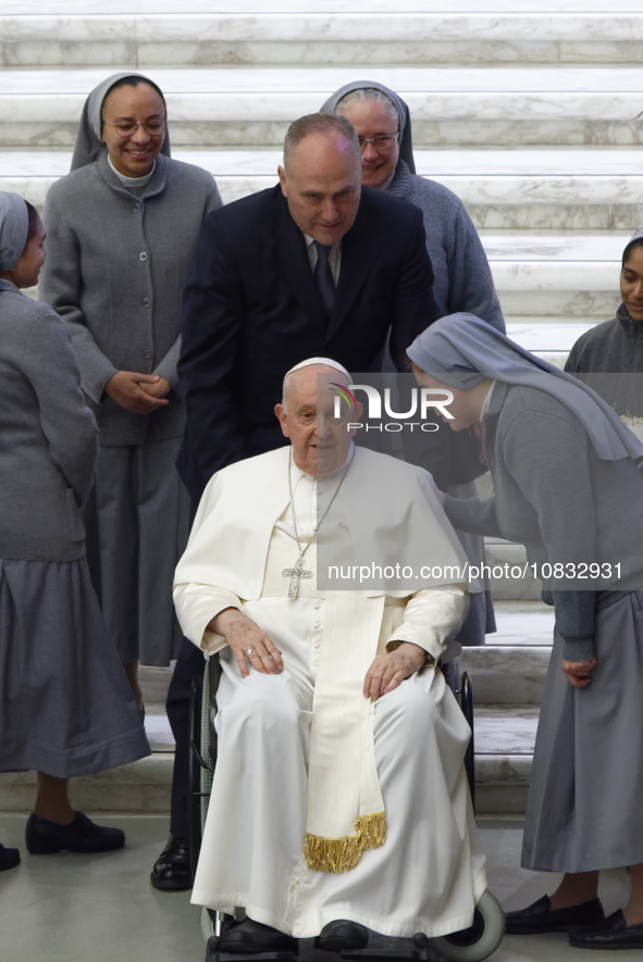 Nuns are greeting Pope Francis during his weekly general audience in the Pope Paul VI hall at the Vatican, on December 6, 2023. 