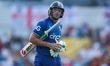 England's Jos Buttler is leaving the field after being dismissed for a duck during the Thi...