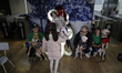 Girls and boys are delivering letters to dogs that were rescued at the Mixcoac metro stati...