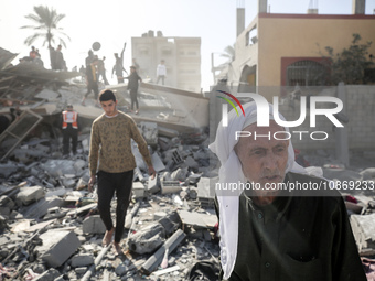 Palestinians are gathering around the destroyed home of the Hajj family following an Israeli bombardment at Nuseirat camp in the central Gaz...
