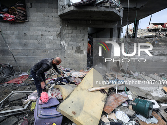 A Palestinian child is sitting amid destroyed buildings following Israeli strikes on the al-Maghazi refugee camp in the central Gaza Strip,...