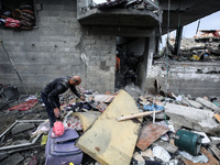 A Palestinian child is sitting amid destroyed buildings following Israeli strikes on the al-Maghazi refugee camp in the central Gaza Strip,...