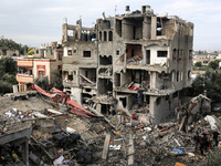 Palestinians are searching through building rubble for survivors following Israeli strikes on the al-Maghazi refugee camp in the central Gaz...