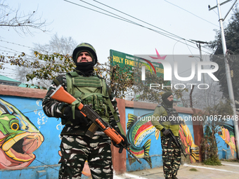Indian paramilitary troopers are standing outside the Holy Family Catholic Church on Christmas Day in Srinagar, Indian Administered Kashmir,...