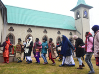 People are dancing in the Holy Family Catholic Church on Christmas Day in Srinagar, Indian Administered Kashmir, on December 25, 2023. (