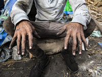 An Egyptian laborer is displaying his blackened hands at the charcoal factory in Al Bostan, Beheira Governorate, Egypt, on December 17, 2023...