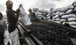 Egyptian laborers are sifting charcoal for shipping at the charcoal factory in Al Bostan,...