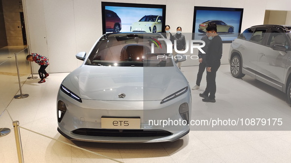 A citizen is experiencing an ET5 car at a NIO electric car store in Shanghai, China, on March 19, 2023. 