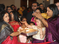 People are receiving blessings during the Durga Puja festival at a pandal (temporary temple) in Mississauga, Ontario, Canada, on October 22,...