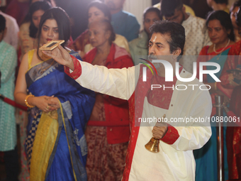 A Bengali Hindu priest is performing special prayers during the Durga Puja festival at a pandal (temporary temple) in Mississauga, Ontario,...