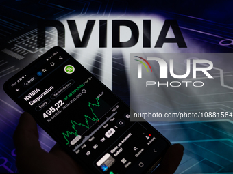 The stock price of NVIDIA Corporation on the NASDAQ market is being displayed on a smartphone, with NVIDIA visible in the background, in thi...