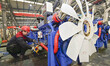 A worker is assembling a generator at a manufacturing enterprise in Qingzhou, East China's...