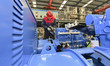 A worker is assembling a generator at a manufacturing enterprise in Qingzhou, East China's...