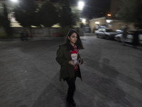 A young Iranian-Christian woman is arriving at the Saint Targmanchats Church in eastern Tehran to take part in a New Year mass prayer ceremo...