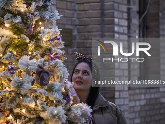 An Iranian-Christian woman is looking at a Christmas tree at the Saint Targmanchats Church in eastern Tehran, before the beginning of a New...
