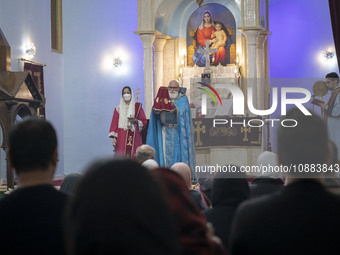 A clergyman is holding a religious symbol at the Saint Targmanchats Church in eastern Tehran, during a New Year mass prayer ceremony, on Jan...