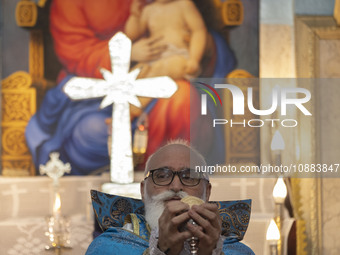 A clergyman is praying at the Saint Targmanchats Church in eastern Tehran, during a New Year mass prayer ceremony, on January 1, 2024. (