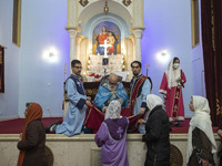 Iranian-Christian women are receiving holy bread from a clergyman at the Saint Targmanchats Church in eastern Tehran, after a New Year mass...