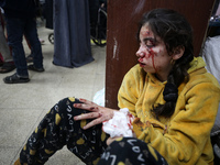 (EDITOR'S NOTE: Graphic content) Wounded Palestinians are receiving treatment at Al-Aqsa hospital in Deir al-Balah, central Gaza Strip, on J...
