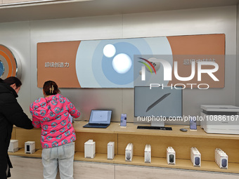 Customers are selecting and buying various Huawei products at its flagship store in Shanghai, China, on January 2, 2024. (