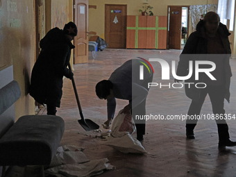 Employees are picking up the rubble in the corridor at school N221, which was damaged during the Russian missile attack, in Kyiv, Ukraine, o...