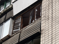 Broken glass is seen in the windows on the balcony of an apartment in the Dorohozhychi district as a result of Russian missile attacks on Ky...