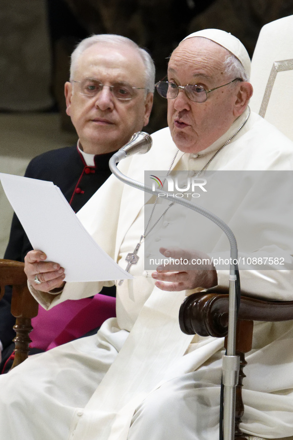 Pope Francis, flanked by Monsignor Leonardo Sapienza, is delivering his speech during his weekly general audience in the Pope Paul VI hall a...