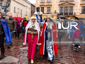 Actors dressed as Polish queens and one of the Wise Man participate in a public Nativity Play performed on the street of Old Town of Krakow,...