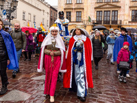 Actors dressed as Polish queens and one of the Wise Man participate in a public Nativity Play performed on the street of Old Town of Krakow,...