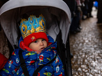 A boy, wearing a paper crown participates in a public Nativity Play performed on the street of Old Town of Krakow, Poland on January 6, 2024...