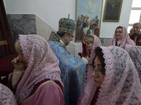Iranian-Armenian clergywomen are praying while a clergyman is holding a holy bible at the St. Vartan Armenian Church in central Tehran, Iran...