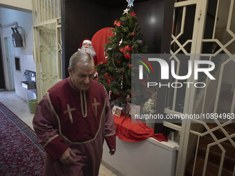 An Iranian-Armenian clergyman is walking past Christmas decorations at the St. Vartan Armenian Church in central Tehran, on January 6, 2024,...
