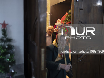 An elderly Iranian-Armenian couple is walking past Christmas decorations at the St. Vartan Armenian Church in central Tehran, on January 6,...