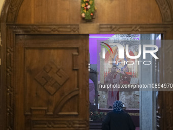 An elderly Iranian-Armenian woman is arriving at the St. Vartan Armenian Church in central Tehran to participate in a Christmas mass prayer...