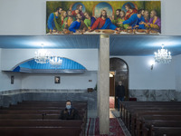An elderly Iranian-Armenian woman is sitting at the St. Vartan Armenian Church in central Tehran, attending a Christmas mass prayer ceremony...