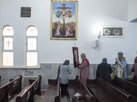 Iranian-Armenian clergymen are praying at the St. Vartan Armenian Church in central Tehran on January 6, 2024, as one of them is carrying a...